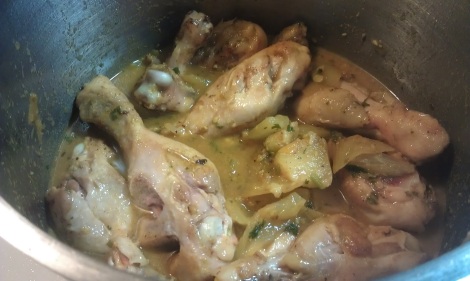 Browned chicken drumsticks returned to pot of spices and liquids. (photo)
