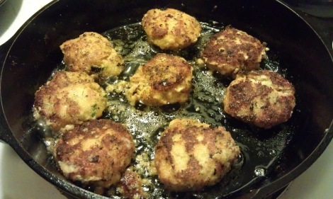 Fish patties frying in a cast iron skillet (low-amine, gluten-free, soy-free, dairy-free, low-fat, low-carb, paleo) photo